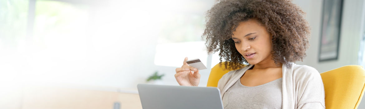 Female on Computer with Debit Card