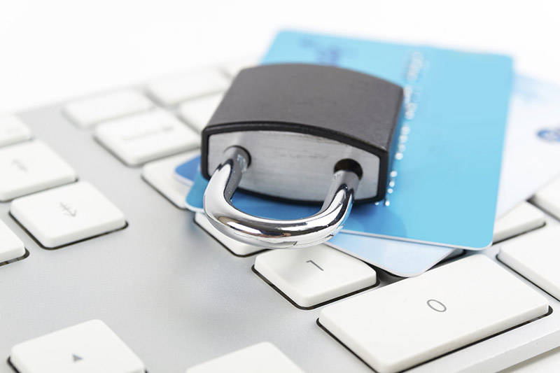 Padlock and card on computer keyboard.