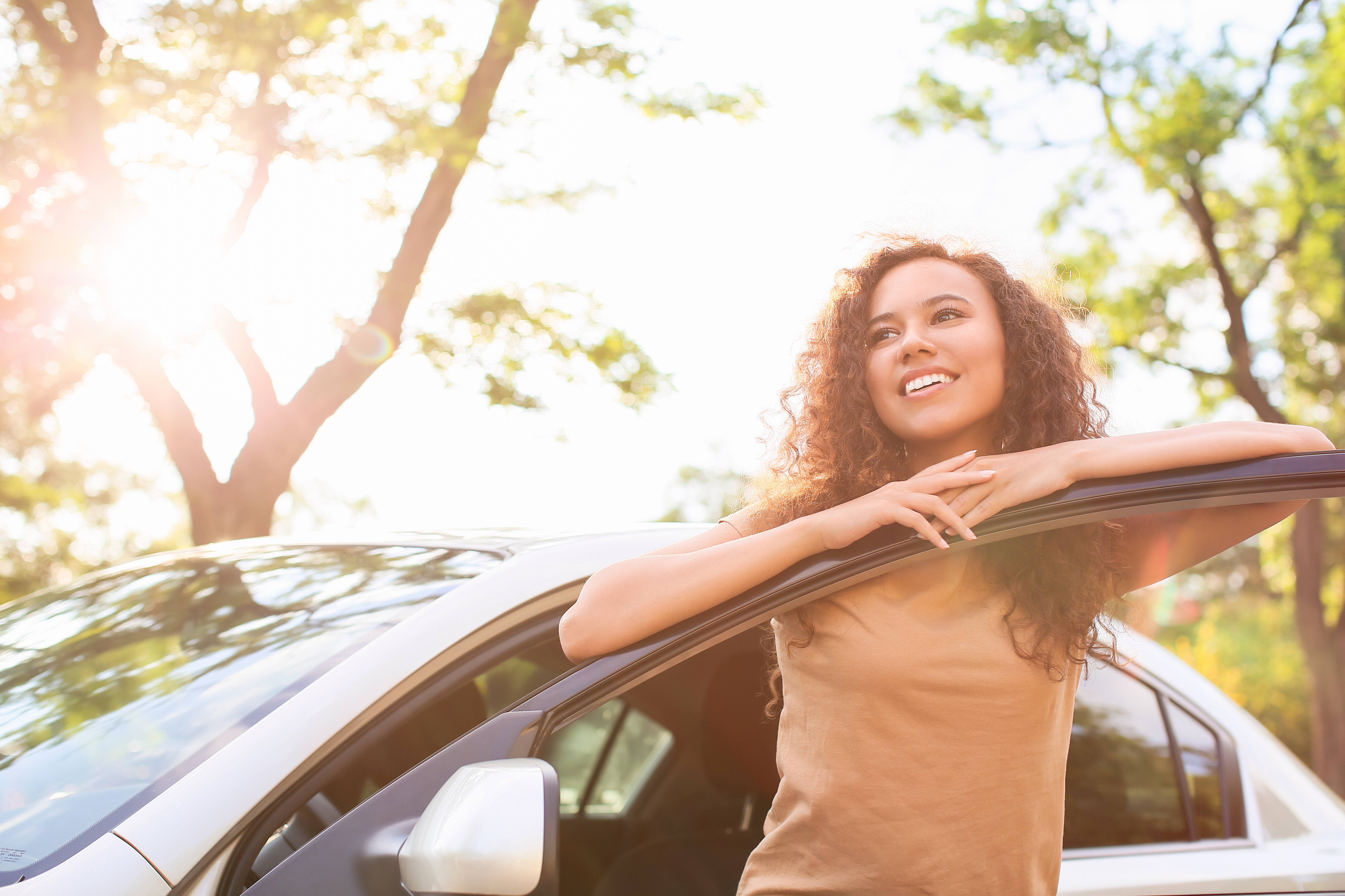 female leaning on car door