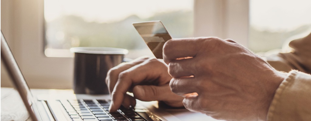 man shopping online using laptop computer and credit card picture